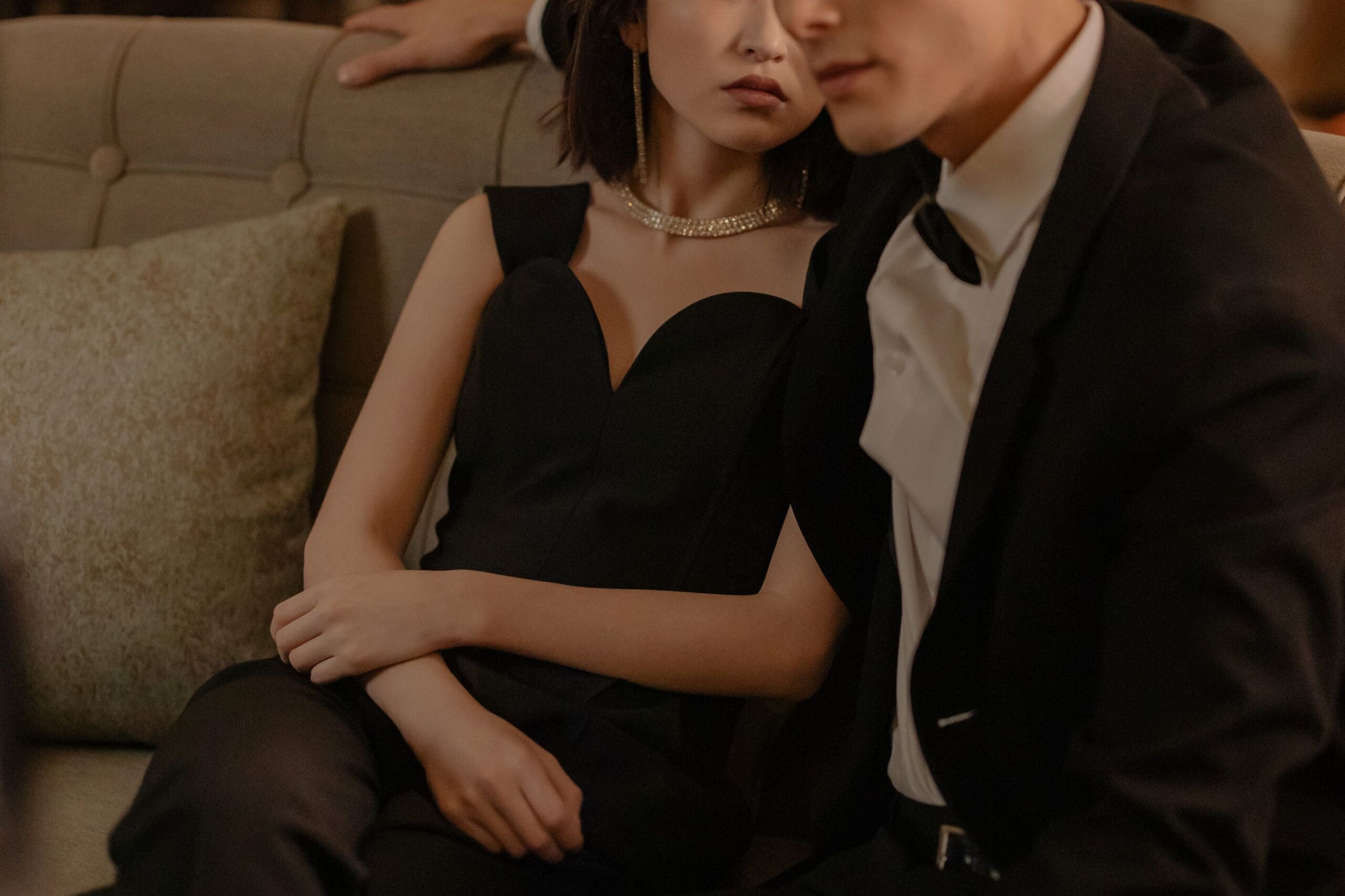 woman in a black dress with a man in a tuxedo